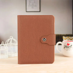 Elegant Brown Leather Notebook with Patterned Cover and Button Closure