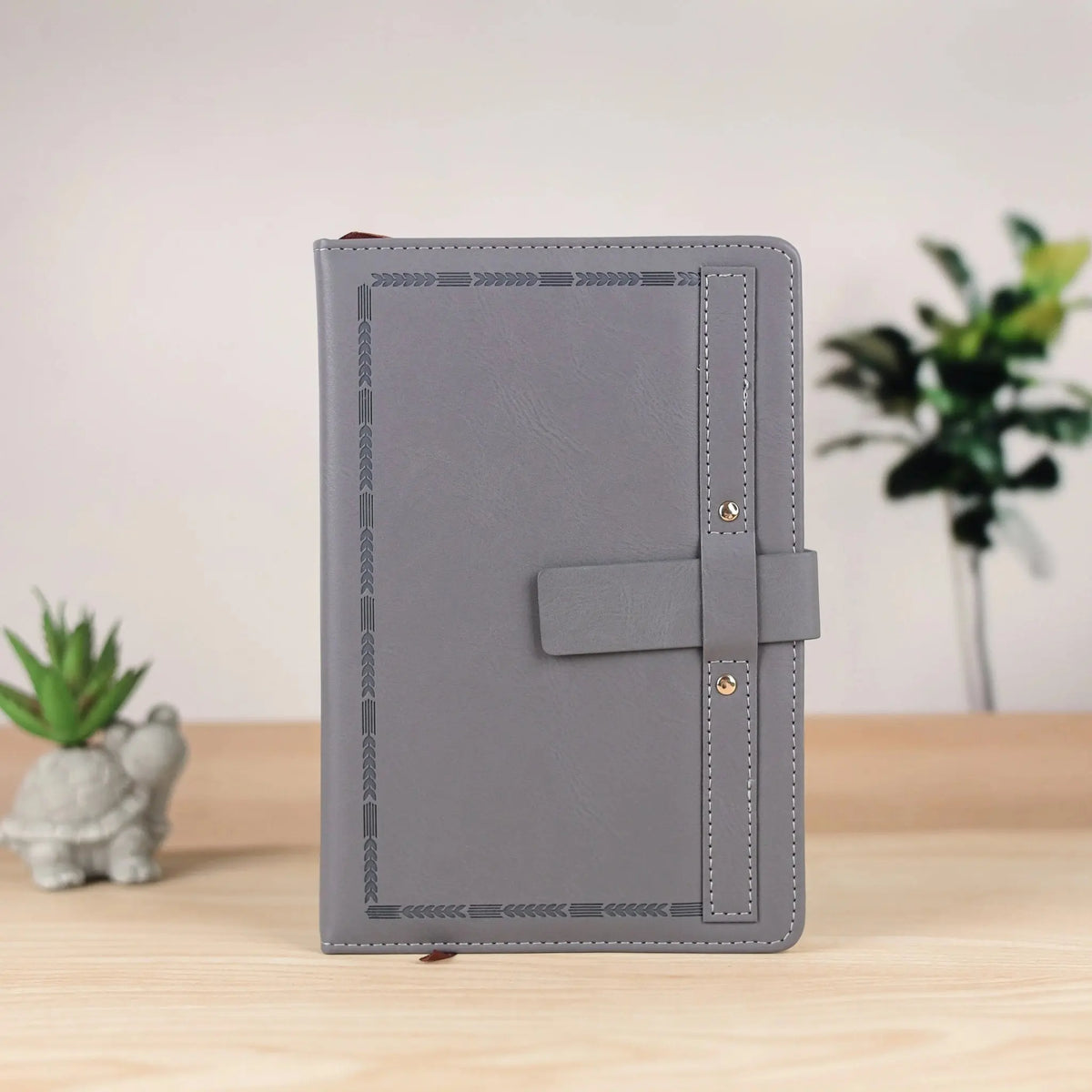 Elegant Gray Leather Notebook with Decorative Border and Strap Closure